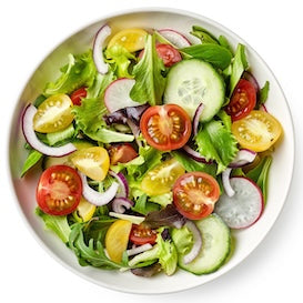 A bowl of fresh salad containing cherry tomatoes, cucumber slices, red onion, radish, and mixed leafy greens, viewed from above.