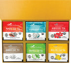 A yellow box contains the Herbal Goodness Variety Tea Gift Set – Organic Teabags (24 Count), featuring six blends: Papaya Leaf, Guava Leaf, Hibiscus, Bamboo Leaf, Graviola Leaf, and Mullein Leaf in colorful packaging.