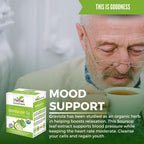 An elderly man with a gray beard drinks tea while looking down. In the foreground is a box of Herbal Goodness Soursop Leaf Tea - Organic Leaf Tea Bags (24 Count), highlighting mood support and health benefits.