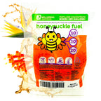 A colorful 2 lb bag of Wellspring Gardens' Honeysuckle Fuel Flowering Plant Fertilizer (water-soluble 10-30-20 blend) features a cartoon bee, bold text, instruction icons, splashes of liquid, and orange honeysuckle flowers.