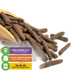 Whole long pepper pods (Piper longum) from Wellspring Gardens spill from a wooden scoop. Icons show USDA zones 9–11, winter dormancy, and recommend a 20-20-20 fertilizer for growing Indian long pepper.