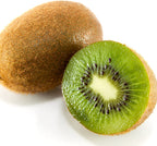 A whole Saanichton Female Kiwi by Wellspring Gardens, with brown fuzzy skin, sits beside a halved fruit revealing bright green flesh, white center, and black seeds—showcasing the result of successful pollination.